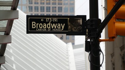 Broadway street road sign, Manhattan downtown financial district architecture, New York City, Fulton street corner. Traffic signage. Yellow traffic light near World Trade Center. Subway entrance.