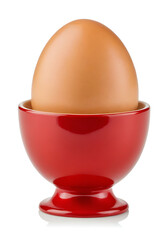 Brown egg in a red egg cup, isolated on white.  Suitable for breakfast, food, or culinary-themed visuals.