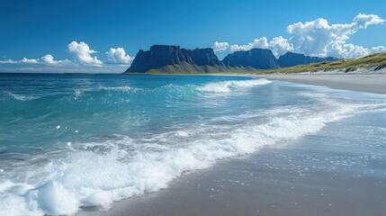A serene beach scene with waves lapping against the shore and majestic cliffs in the background.