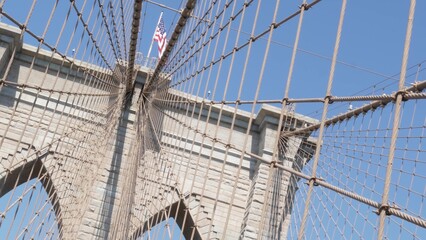 Obraz premium Brooklyn Bridge to Manhattan downtown, cables and blue sky. New York City symbol, USA travel destination. Architecture of United States of America, tourist landmark. Cable-stayed bridge. Dutch angle.