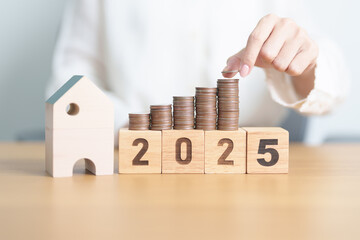 Happy New Year 2025 with house model and Coins stack. real estate, Home loan, tax, investment,...