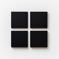 minimalist black square art pieces arranged on a white wall