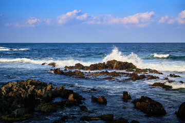 Winter seascape with waves crashing on the seashore rocks © HoyaEuny