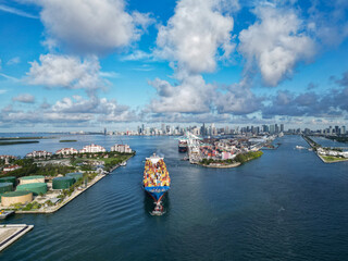Cargo ship services with container in Miami, aerial view. Freight container on cargo vessel. Cargo...