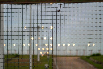 Obraz premium A close-up view of the approach lighting system (ALS) at an airport runway. These specialized lights guide pilots during the final approach and landing, ensuring safety.