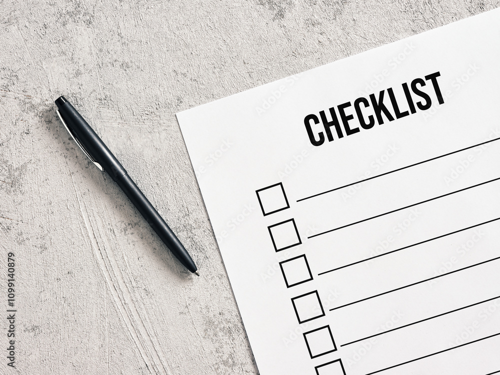 Poster checklist and pen resting on a grey table for efficient task management