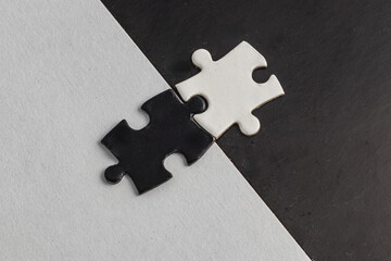 Opposite day concept,white and black puzzle pieces with oposite background color