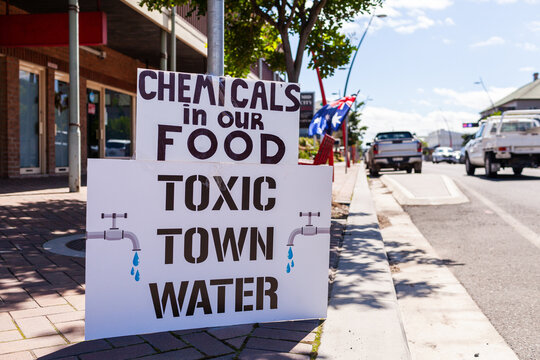 Protest sign set up on pavement along street of country town of Singleton in Hunter Valley