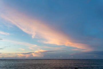 Fototapeta premium Sunset sky over the tranquil waters of Guam showcasing vibrant colors and serene atmosphere