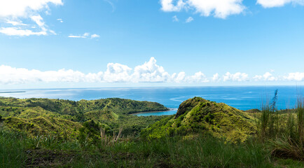 Fototapeta premium Lush green hills and sparkling waters of Guam's breathtaking landscape
