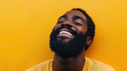 Obraz premium Cheerful Bearded Man Smiling Brightly Against Yellow Background
