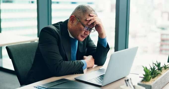 Stress, headache and Asian businessman on laptop for mistake, fail or stock market crash in office in Japan. Migraine, tired and overworked mature manager reading bad news, debt and financial crisis