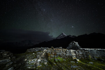 Majestic Annapurna south standing tall in the distance in a starry autumn night