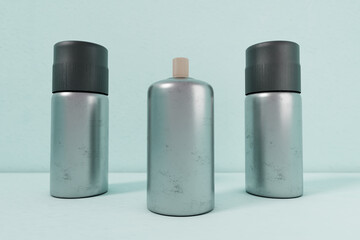 Silver three spray paint metal cans isolated on green gradation front angle for mockup design V7