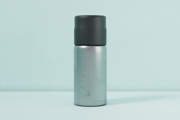 Silver single spray paint metal cans isolated on green gradation front angle for mockup design V5