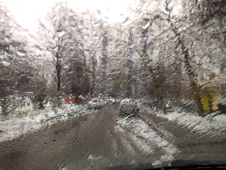 the view through the rain-soaked car window