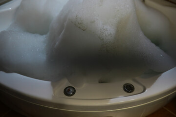 Overflowing Bathtub with Soap Suds and Bubbles Creating a Foam Mountain, Overflow, Spa Concept
