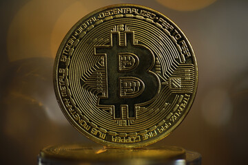 Golden Bitcoin Cryptocurrency Coin with Intricate Design on Blurred Background