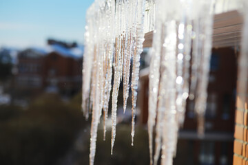 Close-Up of Icicles Hanging from Rooftop on a Sunny Winter Day