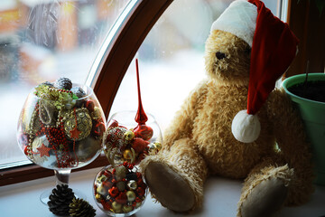 Cozy Christmas Teddy Bear with Ornaments by the Window in Festive Decor