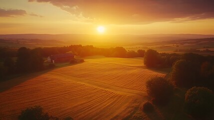 Fototapeta premium Drone shot capturing the warm hues of sunset over farmland, the sky transitioning from gold to deep purple, shadows of trees and barns stretching across the fields, vibrant and natural colors,