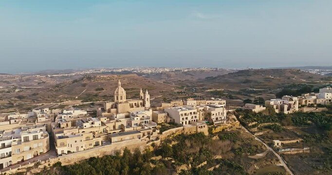 Aerial Panorama of the Parish Church and Historic Zebbug Cityscape in Gozo Malta Displaying Beautiful Mediterranean Architecture. High quality 4k footage
