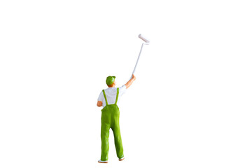 A miniature figurine of a painter holding a long-handled roller brush, isolated on white background with clipping path