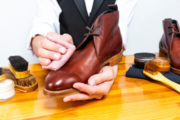 Extreme Closeup of Hands of Young Professional Caucasian Male Shoes Cleaner At The Table with...