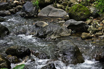Beautiful, aesthetic and artistic river rocks with clear water in rural Asia Indonesia