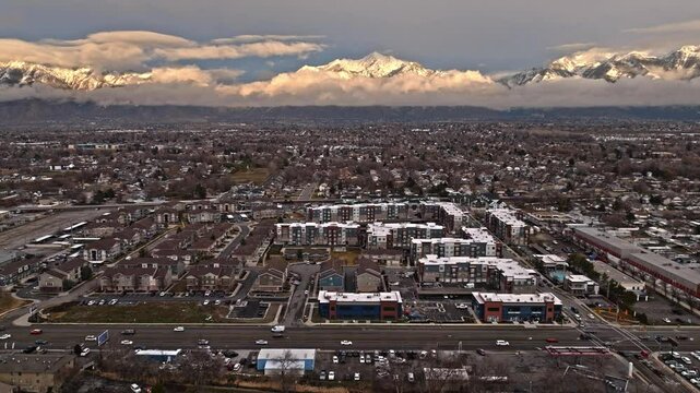 Flying over State Street on Midvale Utah neighborhood with incredible mountain views