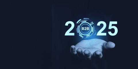 Business strategy concept for 2025 with a B2B focus displayed on a futuristic interface in a hand.
