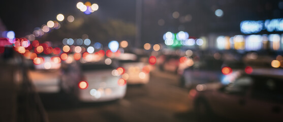 Blurred car traffic light at night city. Traffic jam in evening rush hour.