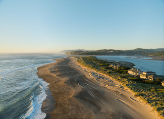 A beach with a house in the distance