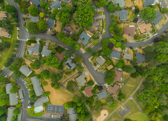 A view of a residential neighborhood with houses and a park