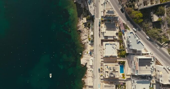 Stunning Aerial Panorama of Bugibba Malta Showing Urban Landscape with Seaside Beaches Marina Yachts and Boats on the Mediterranean Coast. High quality 4k footage