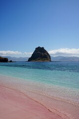 Pink Sand Beach with Tropical Island in Backdrop - Turquoise Waters and Clear Skies