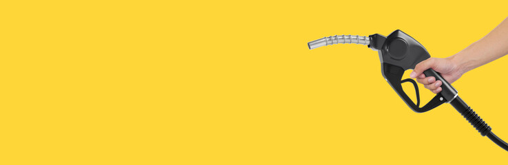 Hands holding Fuel nozzle on yellow background