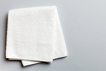 Top view of white towels with copy space on colored background