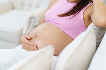 Fototapeta premium Asian pregnant woman relaxing at home.