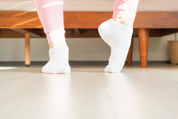 Female legs doing exercises and stretching feet front view.