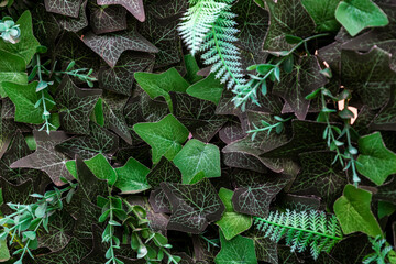 Close-up of a vertical garden with lush, artificial greenery, perfect for modern interior design and eco-friendly decorative concepts.