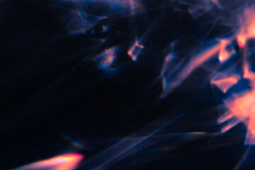Blur colorful warm pink rainbow light leaks on black background. Defocused abstract analog retro film lens flare bokeh overlay or screen filter effect. Glow Vintage prism, water caustic, surreal light