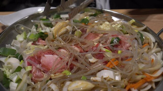 Korean food cooking wheat noodle kalbi fired on pan Korea large style