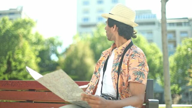 Tourist feeling lost reading a paper city map