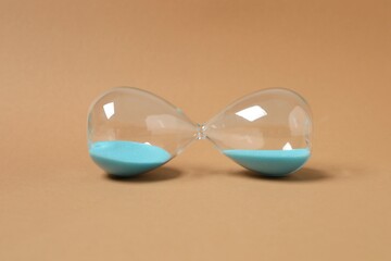 Modern hourglass on color background. Hourglass time concept for business deadline, urgency and...