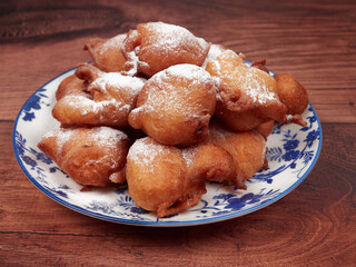 Traditional doughnuts poured with the spoon