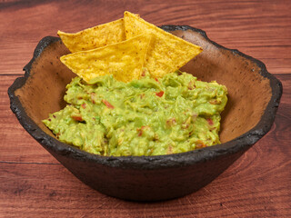 Fresh Guacamole with Tortilla Chips in Rustic Bowl
