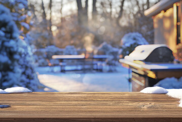 Obraz premium wooden table and winter party in backyard garden with grill BBQ, blurred background