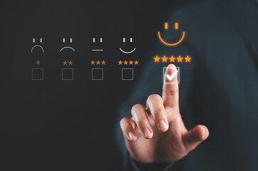 Hand touching and doing mark to select smiley face icon for evaluate product and service, customer...
