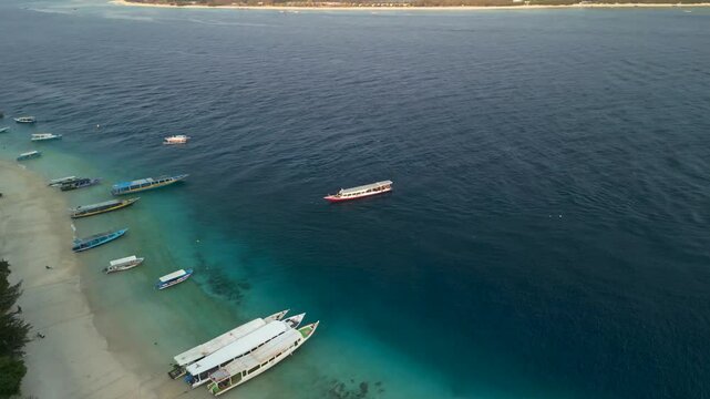 Aerial view of Gilli Trawangan with boats on the turquoise sea, Bali, Indonesia.
